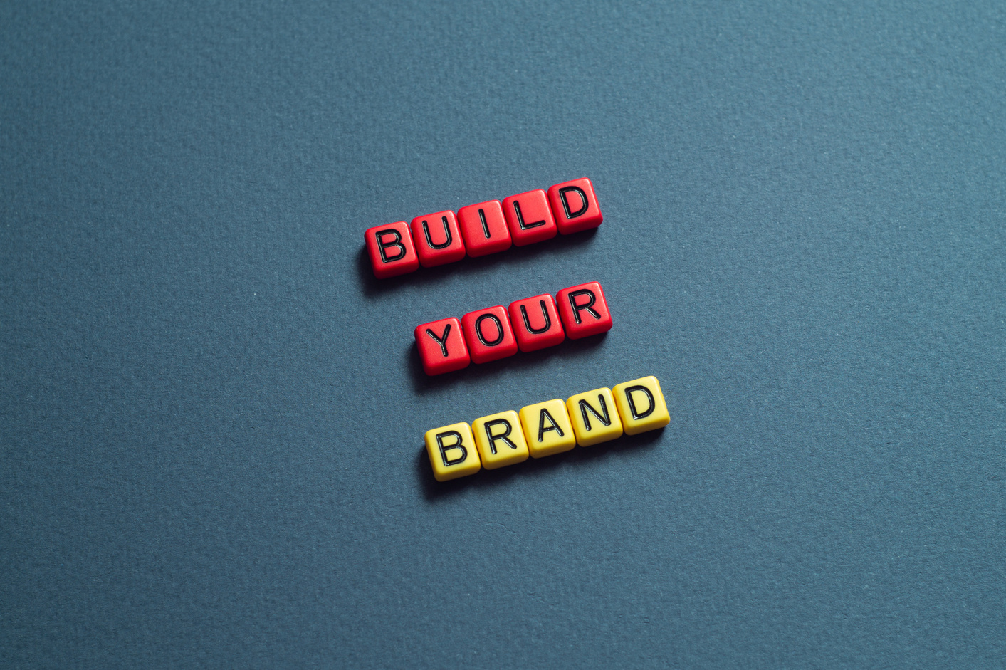 Build your brand - word concept on cubes, text